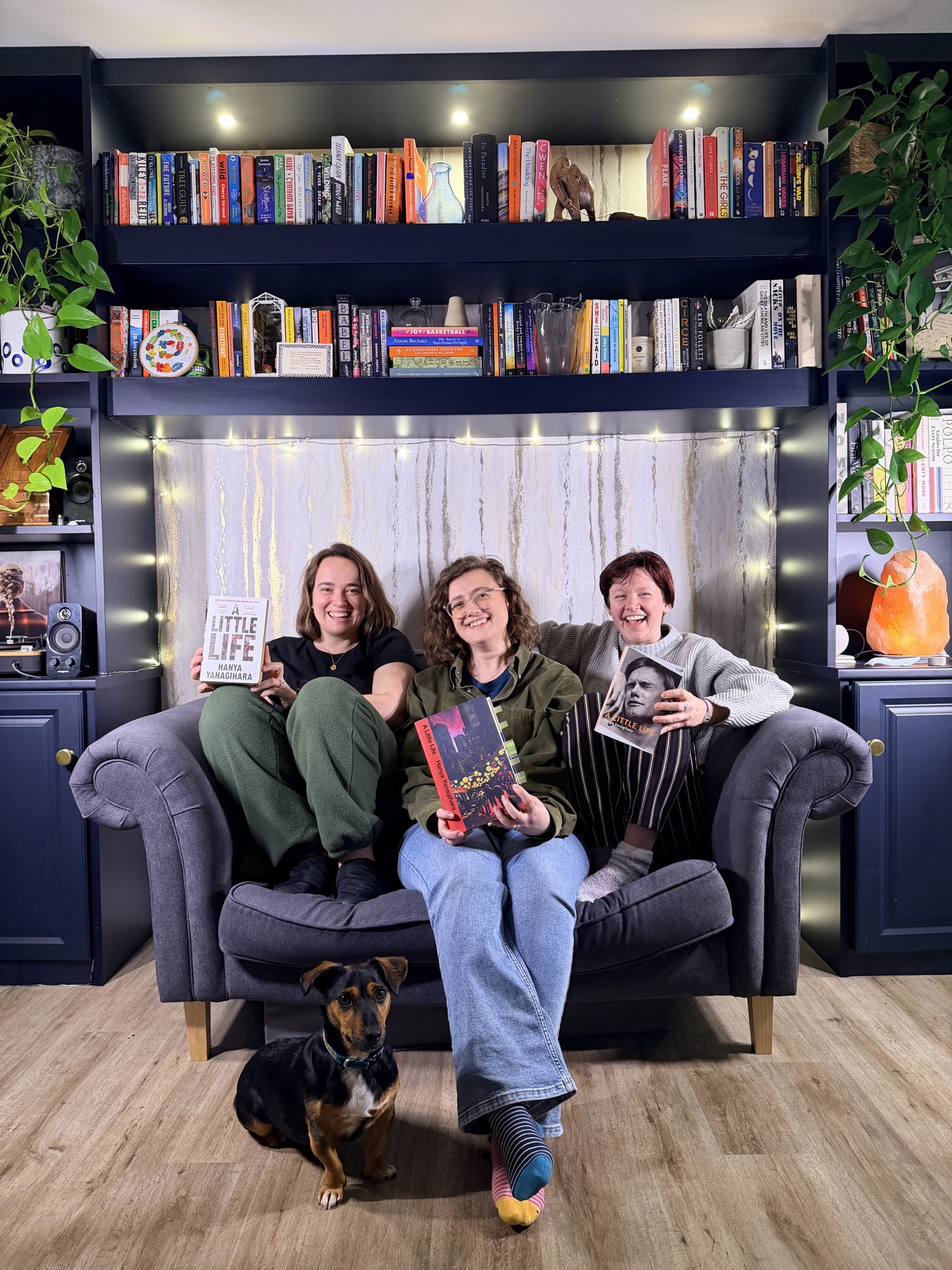 Sarah, Sophie and Sallie sitting on a couch in front of a bookshelf
